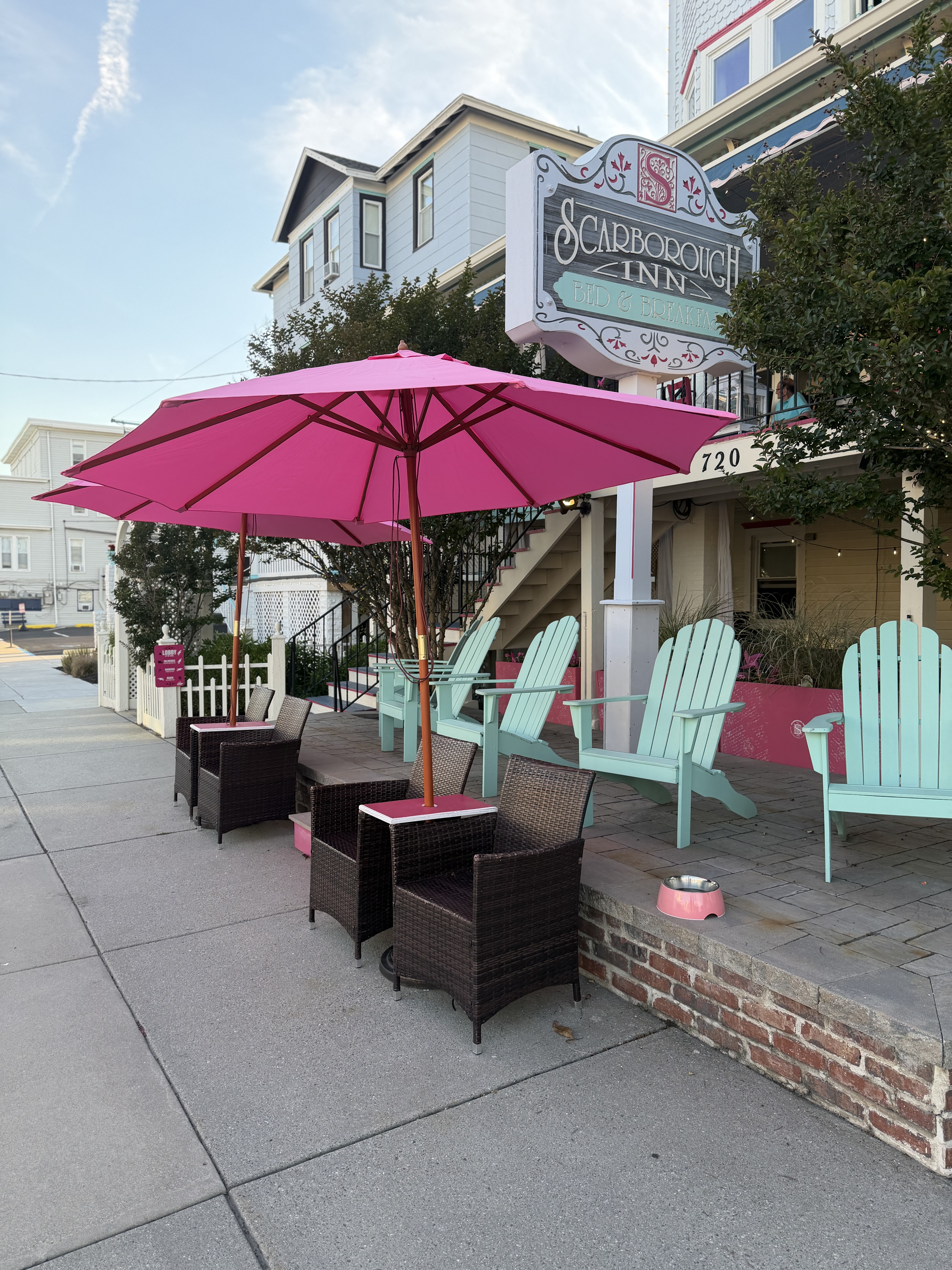 Scarborough Inn exterior with porch seating and sign